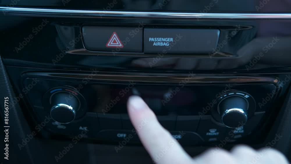 Emergency gang after accident. A view of female finger turn on the emergency gang on the car panel after accident in the street. Emergency gang after accident. A view of female finger turn on the emergency gang on the car panel after accident in the street.