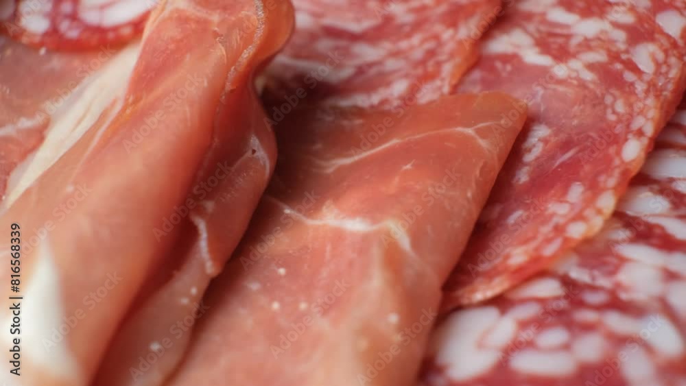 Cold cuts, salami, jamon and sausages spinning close-up. Cold cuts, salami, jamon and sausages spinning close-up.