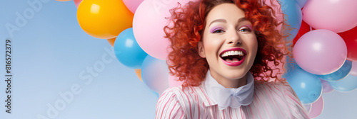 a woman with red curly hair and a bunch of balloons © Elena