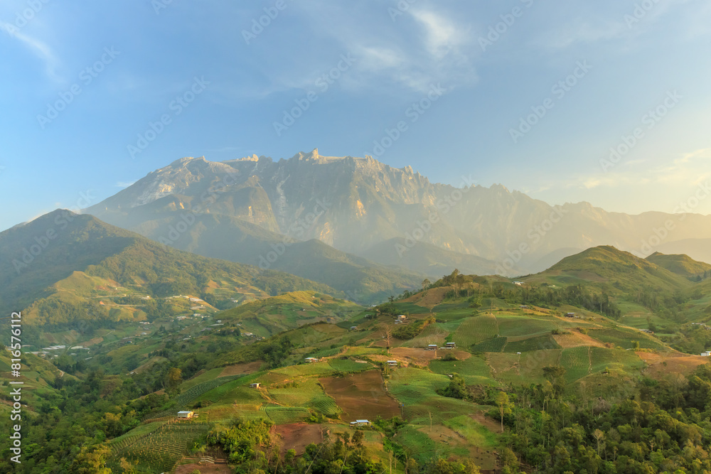 Kundasang Sabah landscape with cabbage farm and Mount Kinabalu at far background during morning. Kundasang Sabah landscape with cabbage farm and Mount Kinabalu at far background during morning.