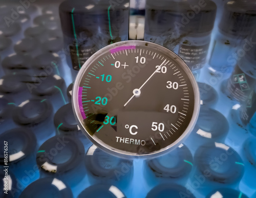 Refrigerator analogue thermometer in cold storage unit. Refrigeration safety gauge displaying safe medical reagents stories temperature.