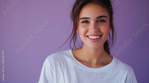 Smiling woman model in white t-shirt on purple background