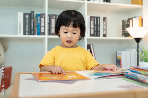 Happy Asian children relax read book at home. daughter and reading a story. learn development  childcare  laughing  education  storytelling  practice  imagine  reduce addiction mobile phone.