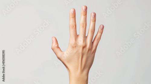 Female hand showing four fingers on white background -