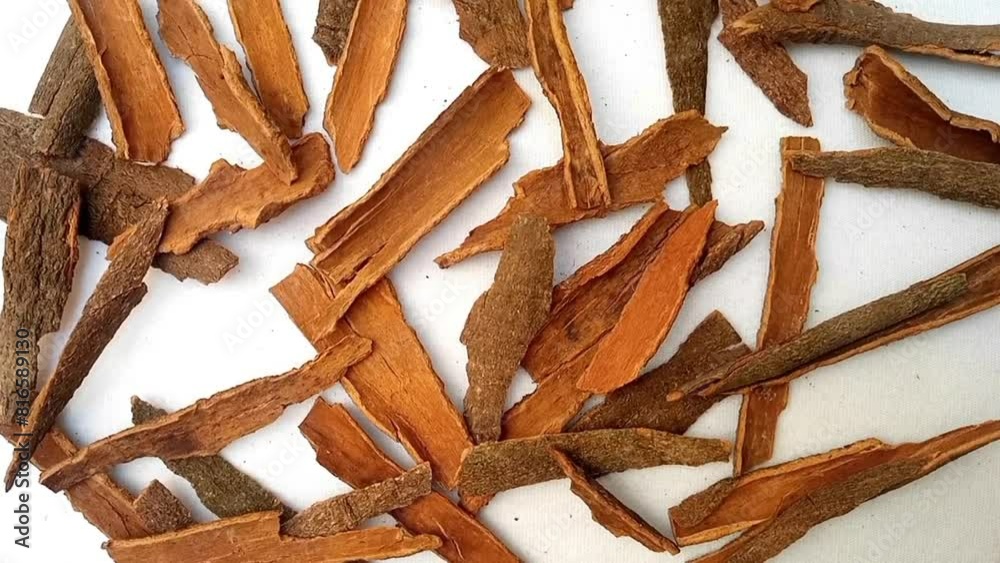 Cinnamon sticks rotating full frame background, top view looped spinning, close up, herbs and spices