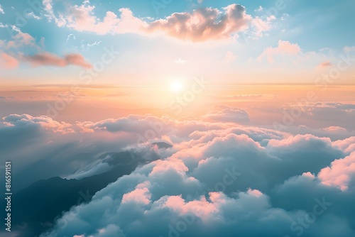 View from above of the sky and clouds with the sun in the background.