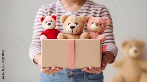 Woman waif holding a box of children's soft toys for charity close-up © dwoow