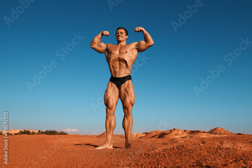 Athletic man posing outdoors. Grain effect used