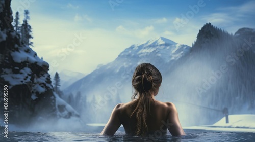 A woman relaxing in a hot spring, with a beautiful mountain landscape in the background. photo