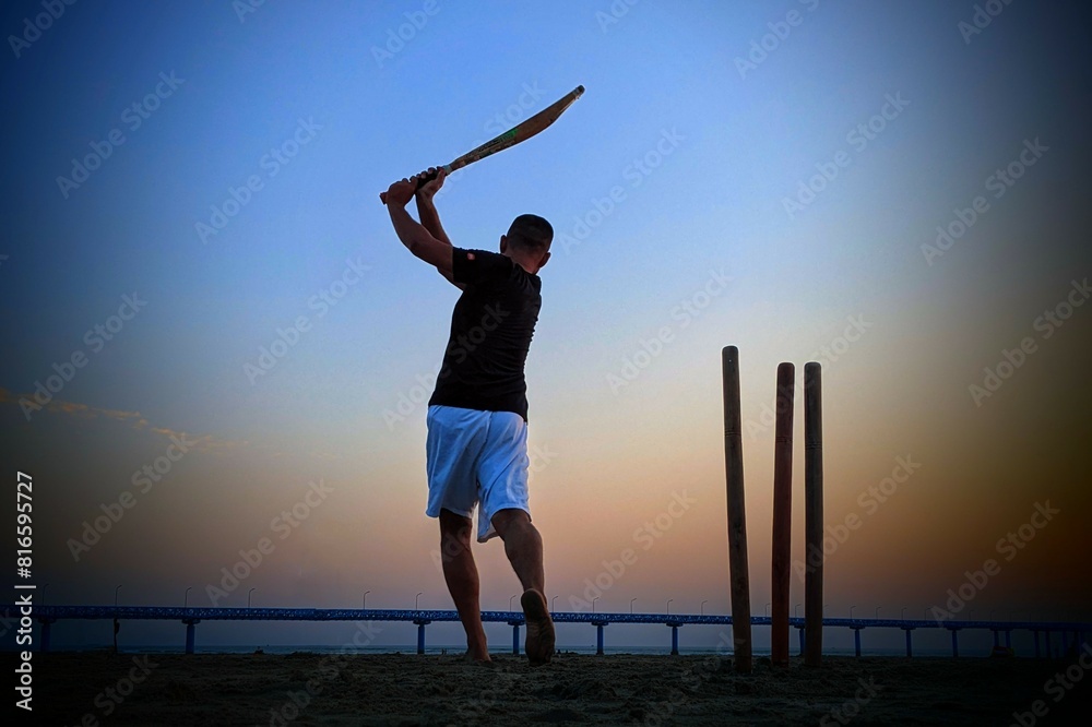 Fototapeta premium Silhouette of a person playing on the beach
