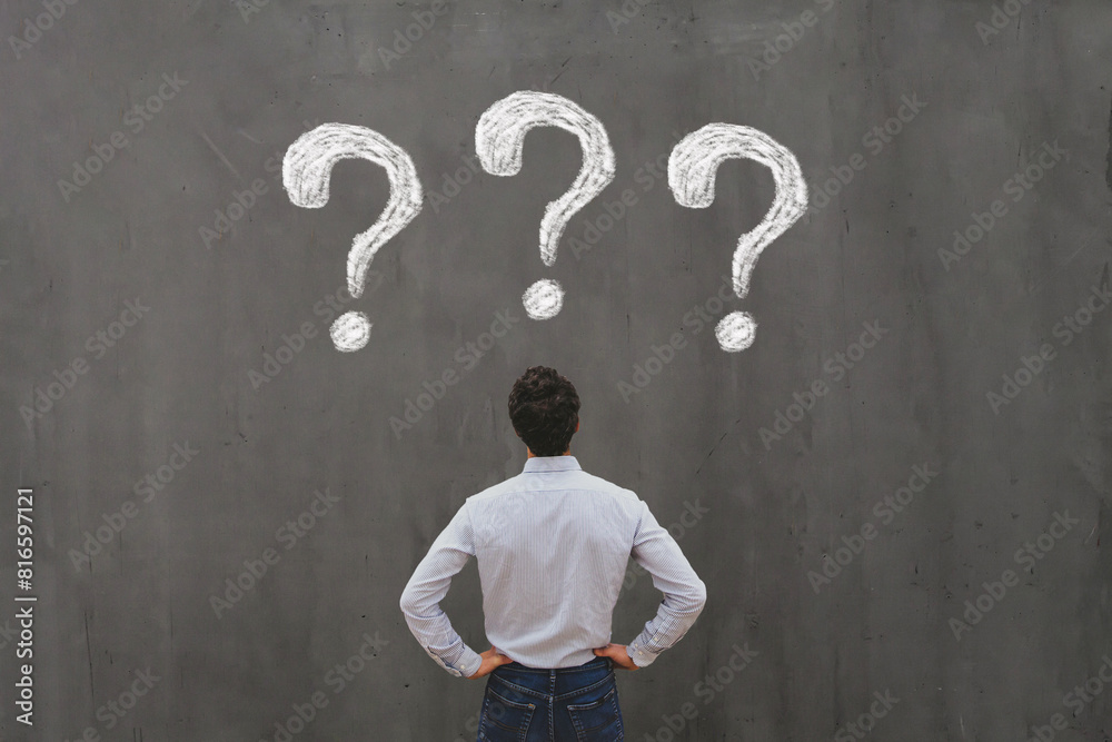 business man looking at questions on chalkboard, ask questions, FAQ concept, uncertainty, interrogation marks business man looking at questions on chalkboard, ask questions, FAQ concept, uncertainty, interrogation marks