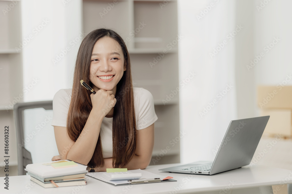 Asian businesswoman working using a laptop computer Marketing report with calculator document on table Plan to analyze financial reports Asian businesswoman working using a laptop computer Marketing report with calculator document on table Plan to analyze financial reports