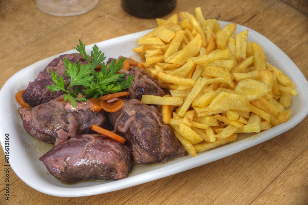 Traditional Portuguese dish: Stewed black pork cheeks, tender and flavorful, served in rustic earthenware. Culinary delight. Traditional Portuguese dish: Stewed black pork cheeks, tender and flavorful, served in rustic earthenware. Culinary delight.