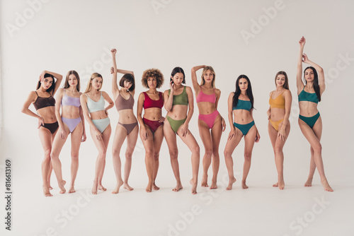 Full size photo no retouch of attractive young women pose models shopping promo wear colorful lingerie natural day light studio background photo