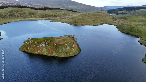 Aerial orbit shot of the island at Llyn Dywarchen in the Eryri National Park, Wales.