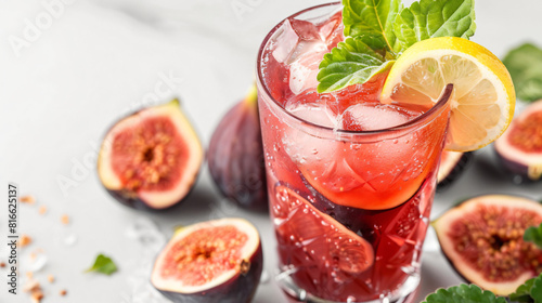 Glass of tasty fig lemonade on white background