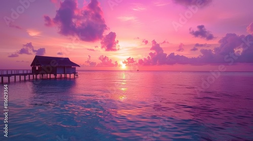 Pink Sunset Over Ocean With Hut in Background