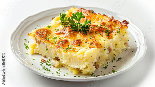 Plate with piece of mashed potato casserole on white b