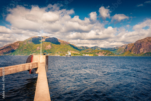 Wonderful summer view of the Norwegian farry crossing through the fjord. Captivating morning seascape of North sea, Norway, Europe. Traveling concept background. © Andrew Mayovskyy
