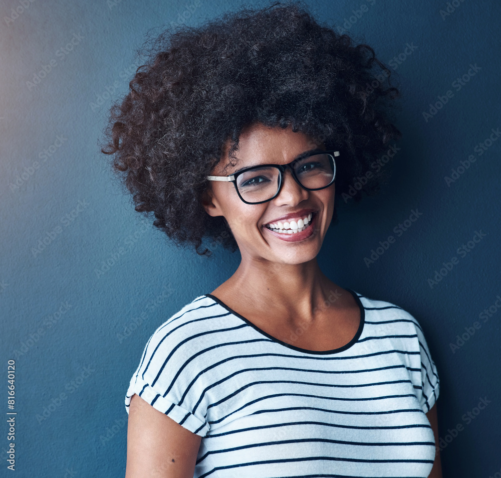 Portrait, funny and woman with glasses, happiness and confident girl on blue studio background. Face, person or model with eyewear, afro or humor for joke, clear vision or gen z with joy and cheerful Portrait, funny and woman with glasses, happiness and confident girl on blue studio background. Face, person or model with eyewear, afro or humor for joke, clear vision or gen z with joy and cheerful