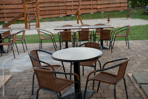 Outdoor coffee terrace with tables and chairs in a summer day