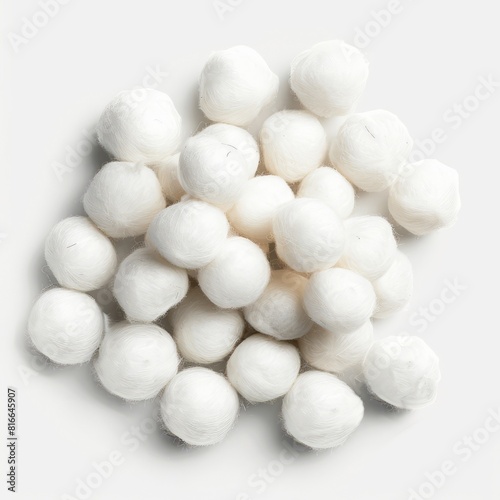 White cotton balls neatly arranged on a clean white surface