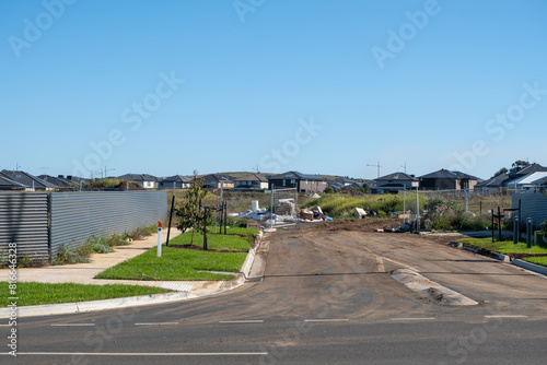 An incomplete road with dead ends covered in dirt, with some illegal hard rubbish dumping,  in a new housing estate. The construction site of new homes and vacant land in the distance. Mount Atkinson photo