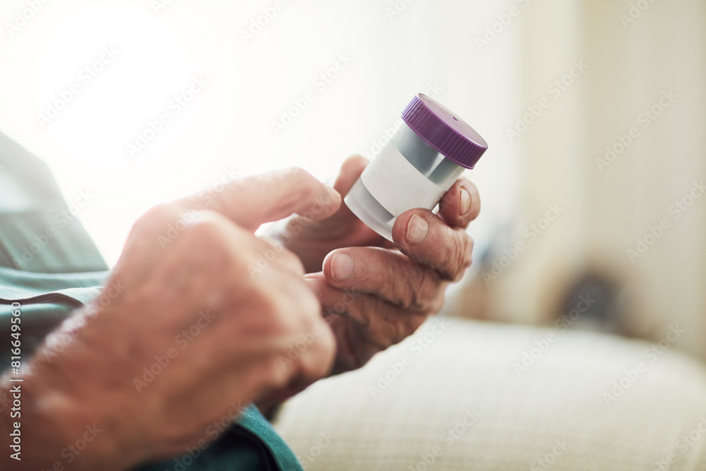 Fototapeta premium Senior man, hands and reading medication with pills for prescription, chronic illness or sickness at old age home. Closeup of elderly male person checking container for medical dose or side effects