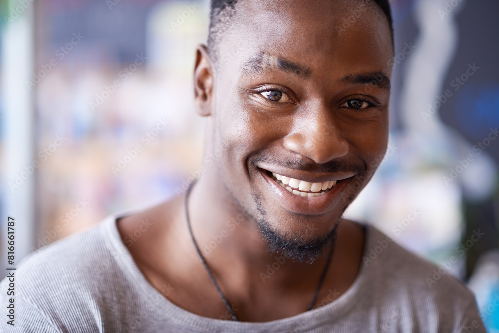Smile, portrait and black man at cafe to relax, cheerful and positive face for leisure at restaurant in Kenya. Facial, cafeteria and happy African person or young customer in casual clothes at shop