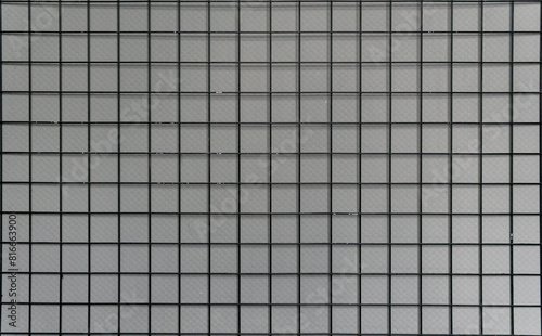Square grid pattern with grey tiles  creating a clean  geometric texture.