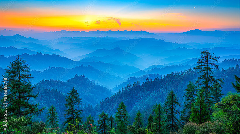 Vibrant sunrise over layered mountain ranges with silhouetted pine trees