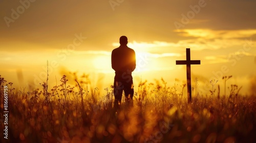Faith In God. Mental Health and Christianity: Silhouette of Human Surrendering to God in Meadow at Sunset photo