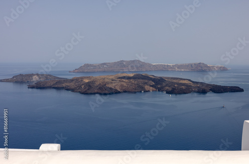 View from Santorini to volcanic island Nea Kamena, Cyclades, Greece photo