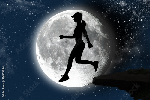 Silhouette of young woman jumping on sky background with moon at night.