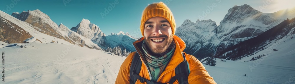 Young male mountaineer smiling on a snowy mountain peak. Young male mountaineer smiling on a snowy mountain peak.