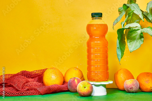 bottle of orange and peaches juices with flying fruits