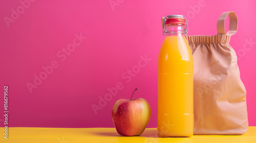 Lunch box bag bottle of juice and apple on color background