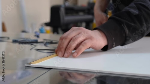 Person applying double sided tape.