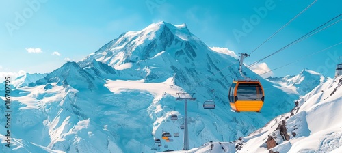 Close up of orange ski lift gondola with snow capped mountain range in the background