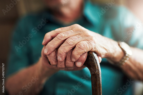 Senior man, hands and support with cane for old age, osteoporosis or care in retirement home. Closeup of elderly, pensioner or male person with a disability or walking stick for stability at house