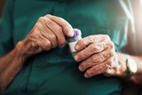 Senior man, hands and medication with pills for prescription, chronic illness or sickness at old age home. Closeup of elderly male person with tablets in container for medical, dementia or arthritis