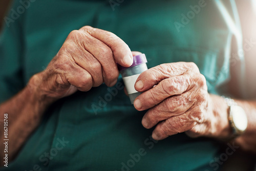 Senior man, hands and medication with pills for prescription, chronic illness or sickness at old age home. Closeup of elderly male person with tablets in container for medical, dementia or arthritis photo