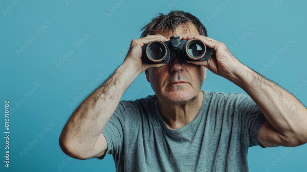 Man Peering Through Binoculars Man Peering Through Binoculars