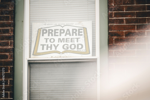a sign reading prepare to meet thy god in a window photo