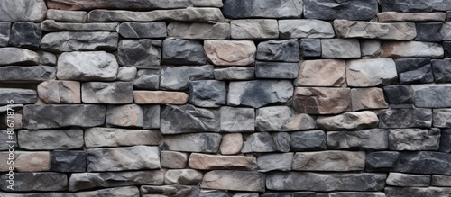 A background of a wall made of stones with a textured appearance suitable for including copy space in an image