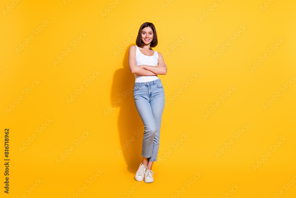 Full body photo of attractive young girl crossed hands confident wear trendy white outfit isolated on yellow color background Full body photo of attractive young girl crossed hands confident wear trendy white outfit isolated on yellow color background
