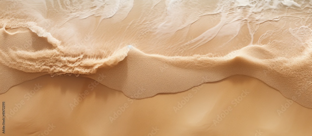Obraz premium A top view of a sandy beach with visible sand texture serving as a backdrop for mockups and advertising. with copy space image. Place for adding text or design