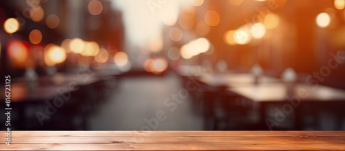 There is a copy space image of a table top with a blurred restaurant in the background