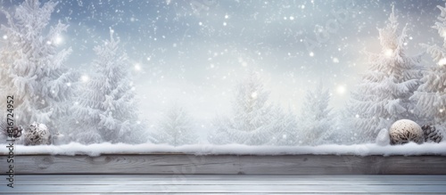 A stunning Christmas backdrop featuring snow covered branches of a tree resting on a wooden table with empty space for adding your own images. with copy space image. Place for adding text or design