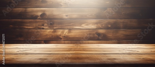 A wooden background showcases a perspective view of an empty light plate with ample copy space for your design